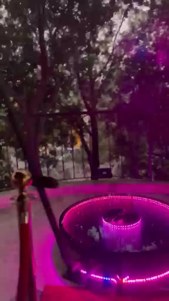 The 360 cam platform glowing at the end of a red carpet between rope stanchions
