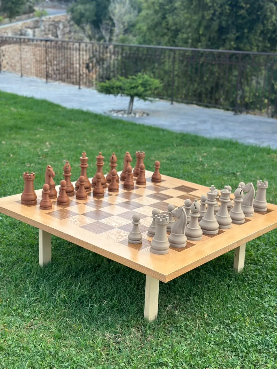 A giant chess set laid out on a lawn