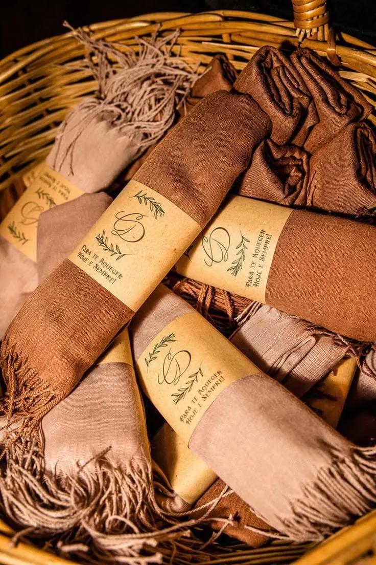 Tan foulards with printed tags gathered in a woven basket