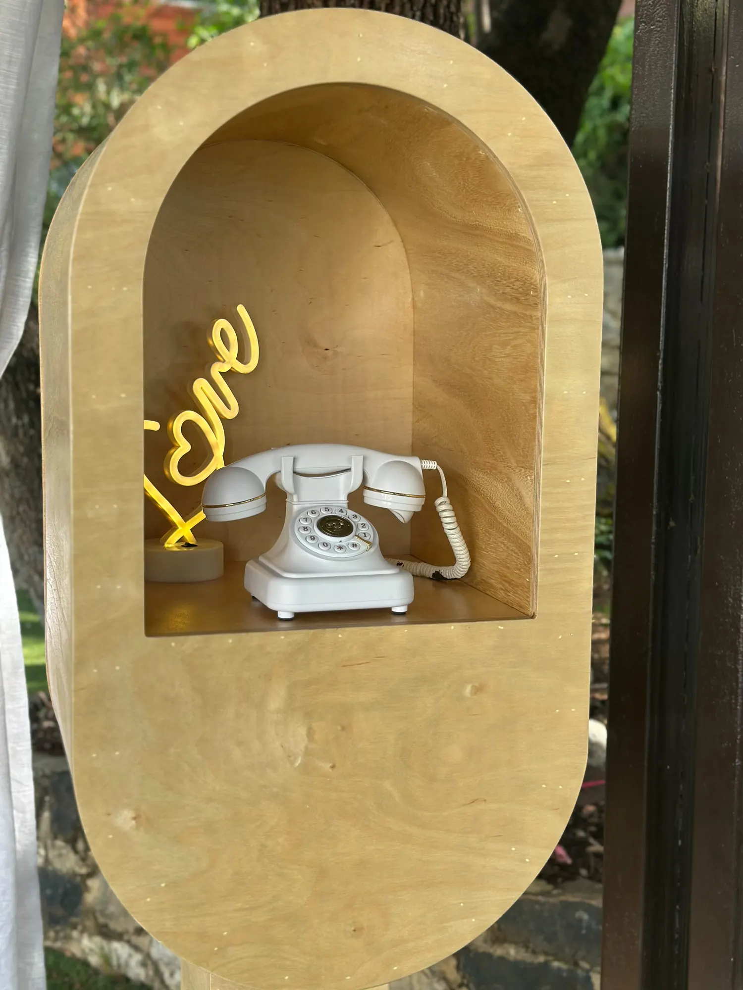 The alcove of the Leave a Message booth with its vintage telephone