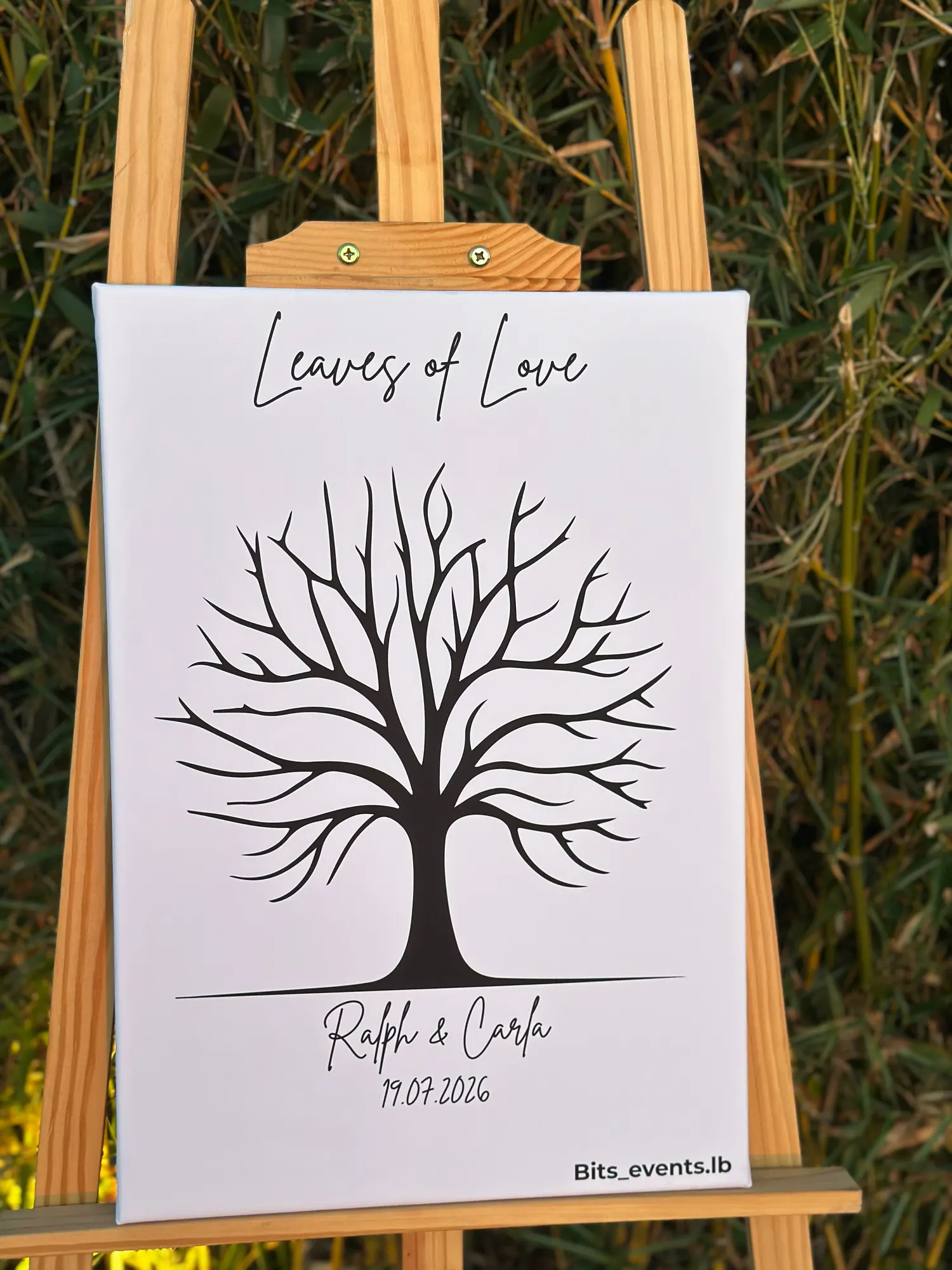 A blank Leaves of Love fingerprint guest book on an easel