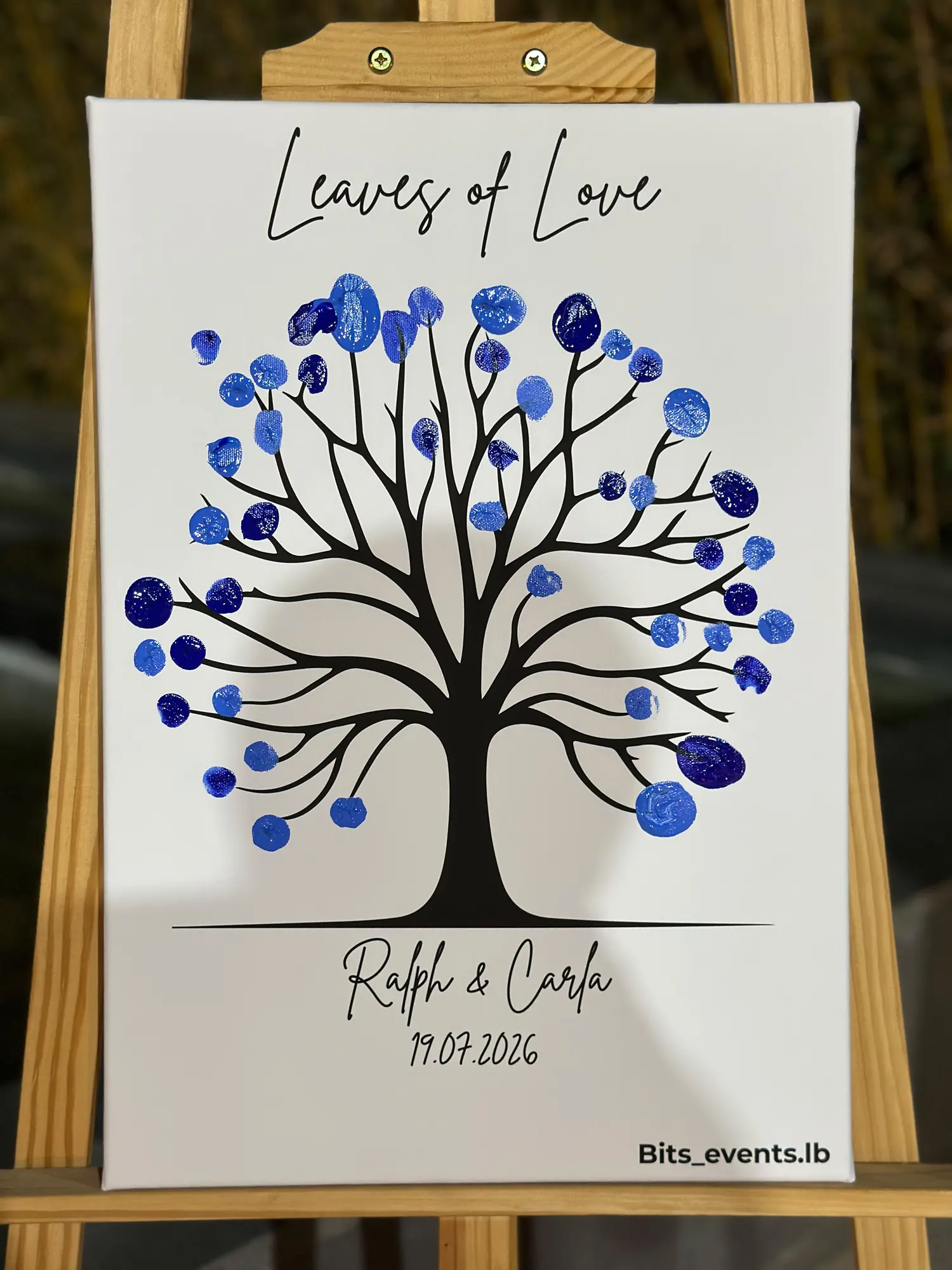 The Leaves of Love guest book filled with blue fingerprints