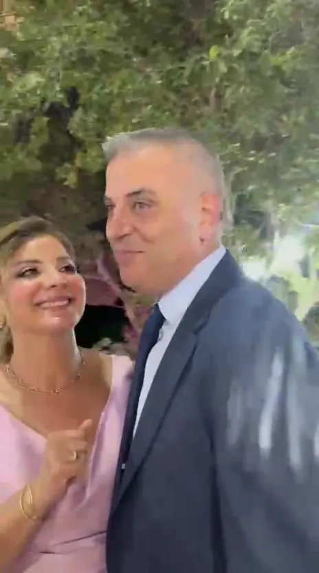 A couple smiling into the mirror photo booth