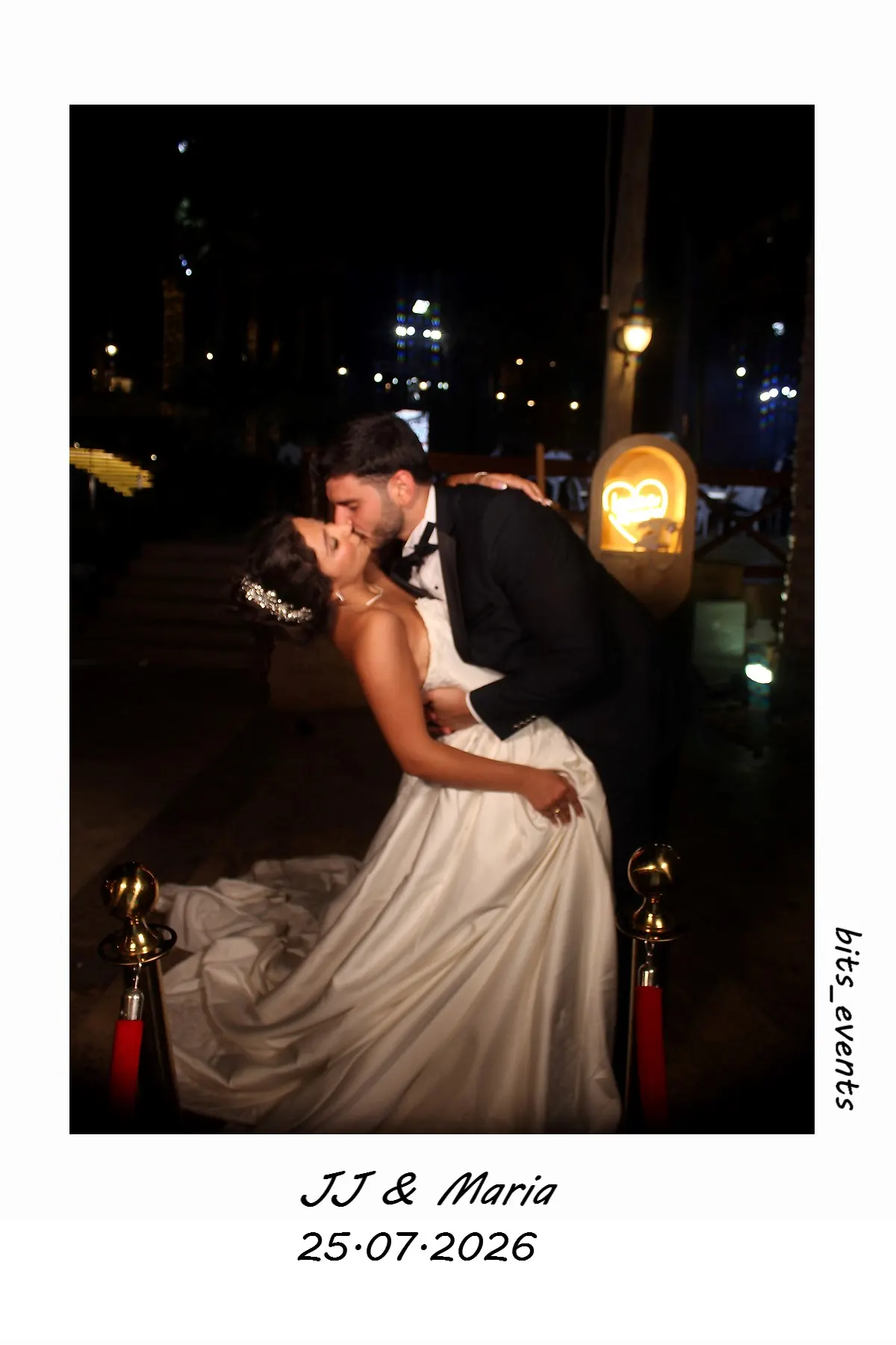 A print from the mirror booth, a couple kissing under the neon heart, with their names and the date across the bottom