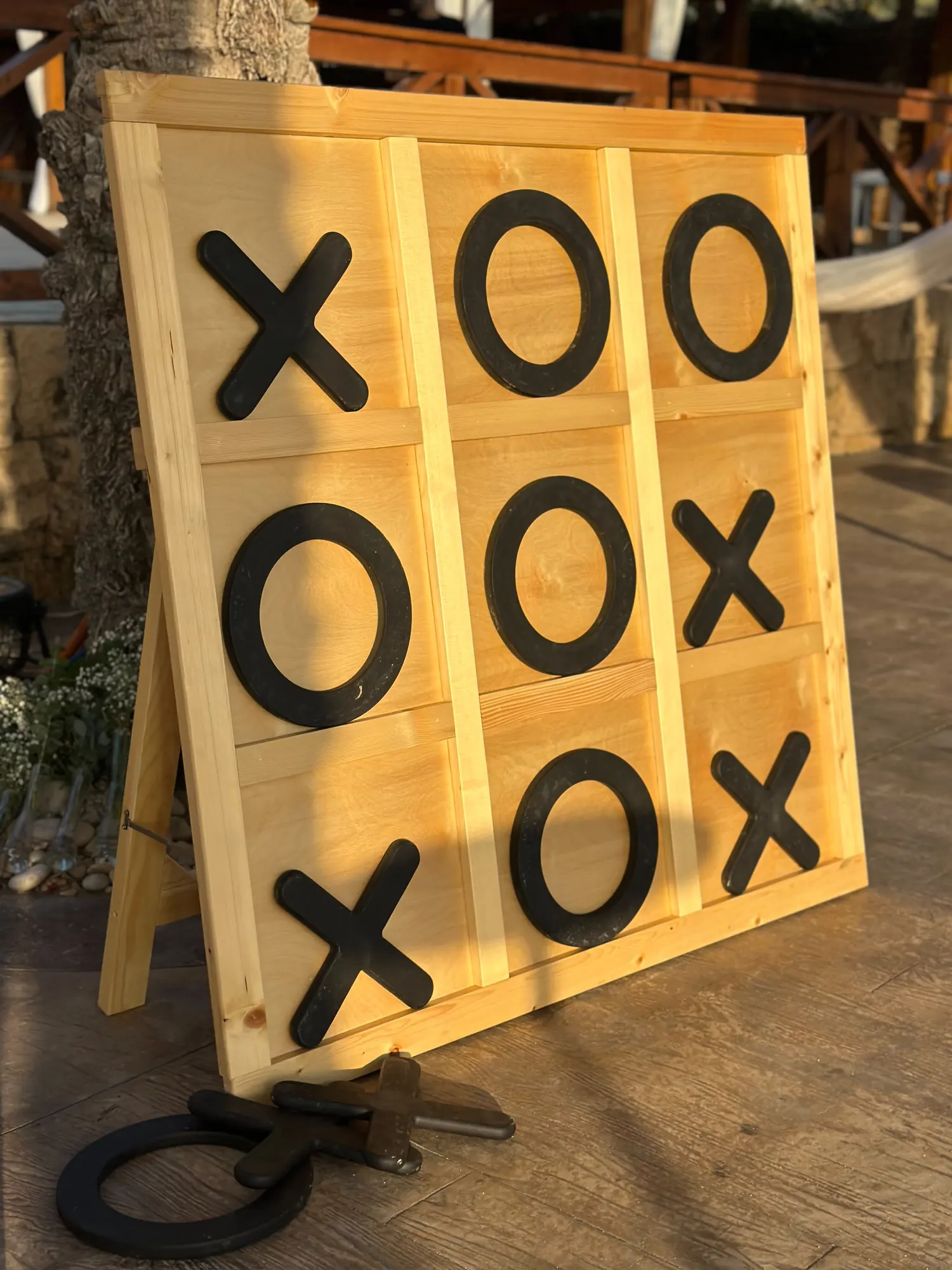 A giant XO board and throwing rings set up for the evening