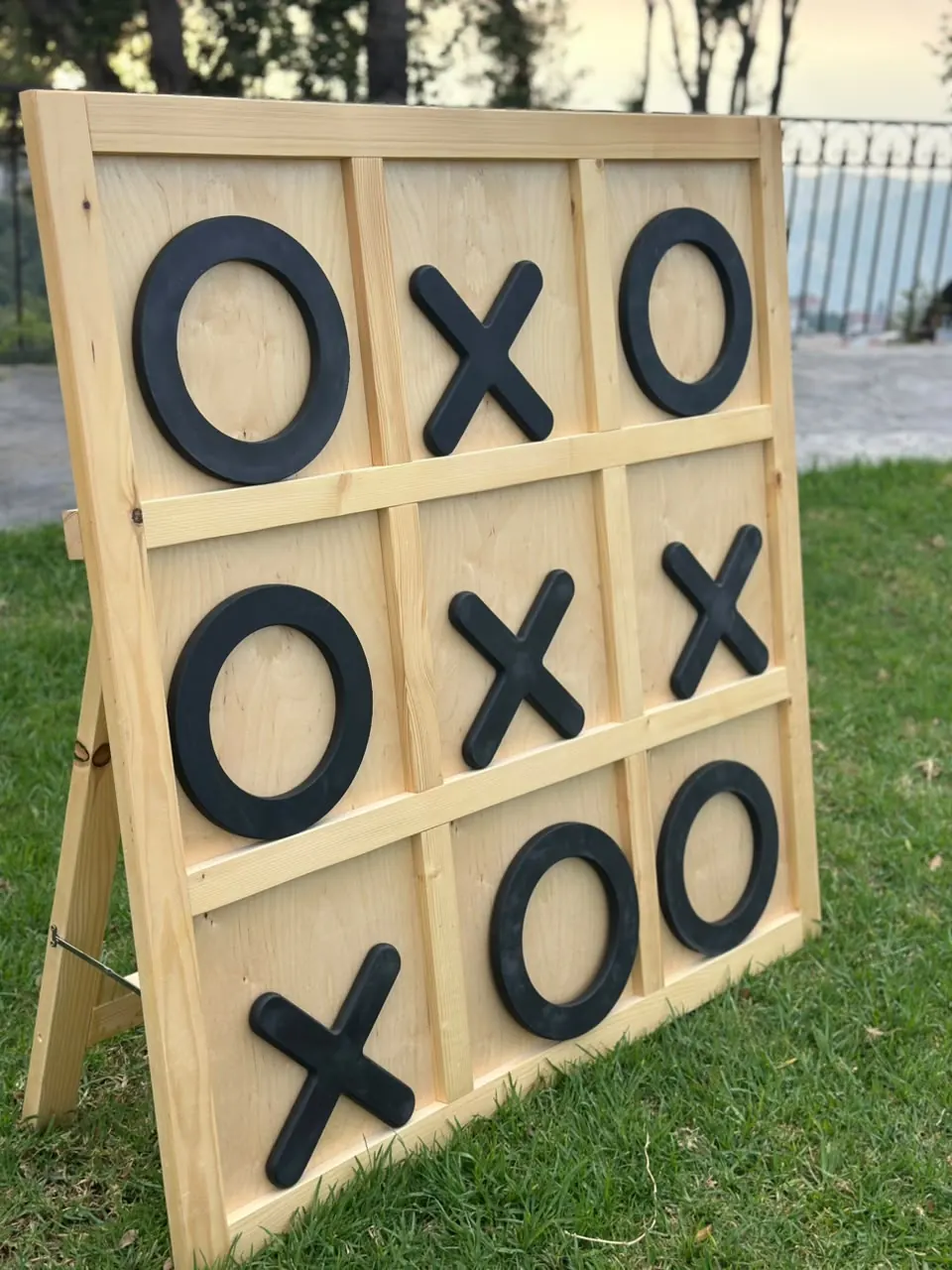 A giant XO board standing on a lawn